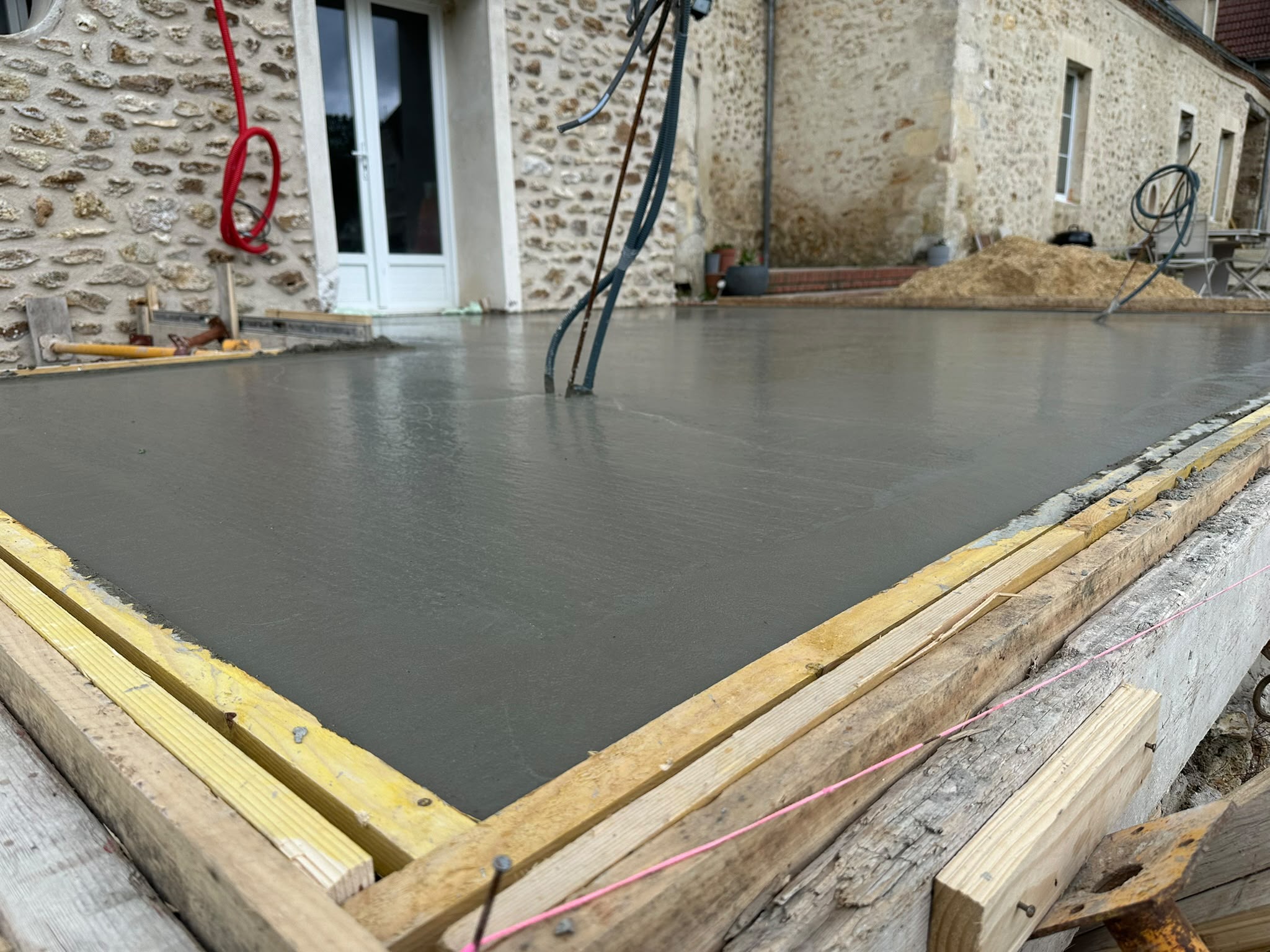 Coulage d'une dalle béton pour une extension aluminium